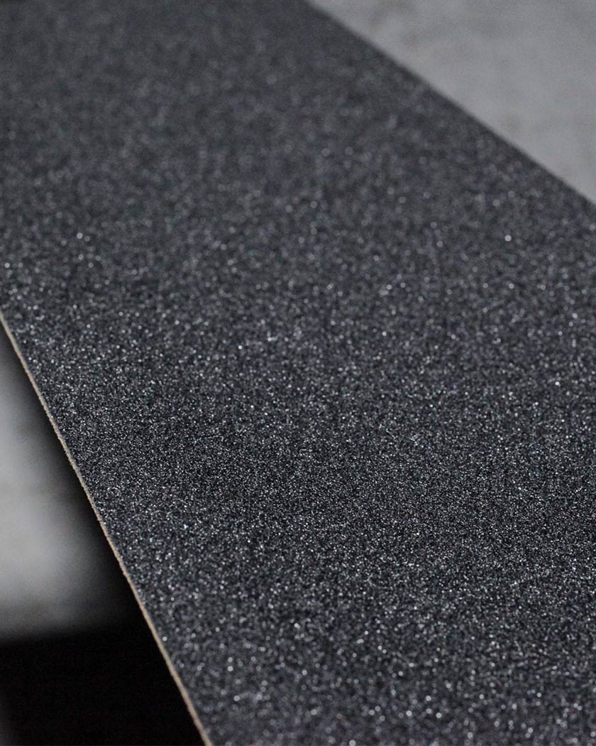 Macro view of textured black skateboard grip tape